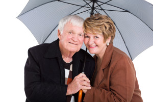 senior husband and wife under an umbrella